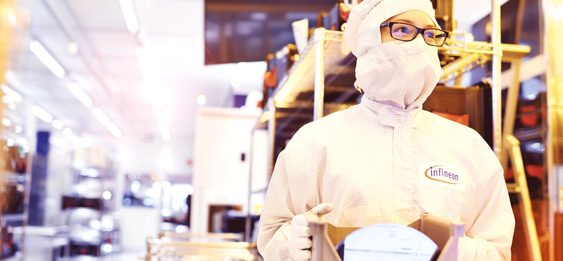 Person with protective mask working in high tech factory